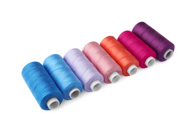 Set of different colorful sewing threads on white background