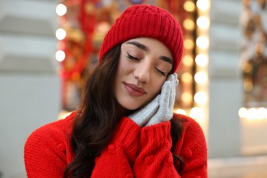 Photo of Portrait of beautiful woman on blurred background. Winter time