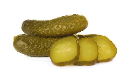 Photo of Tasty sliced and whole pickled cucumbers on white background