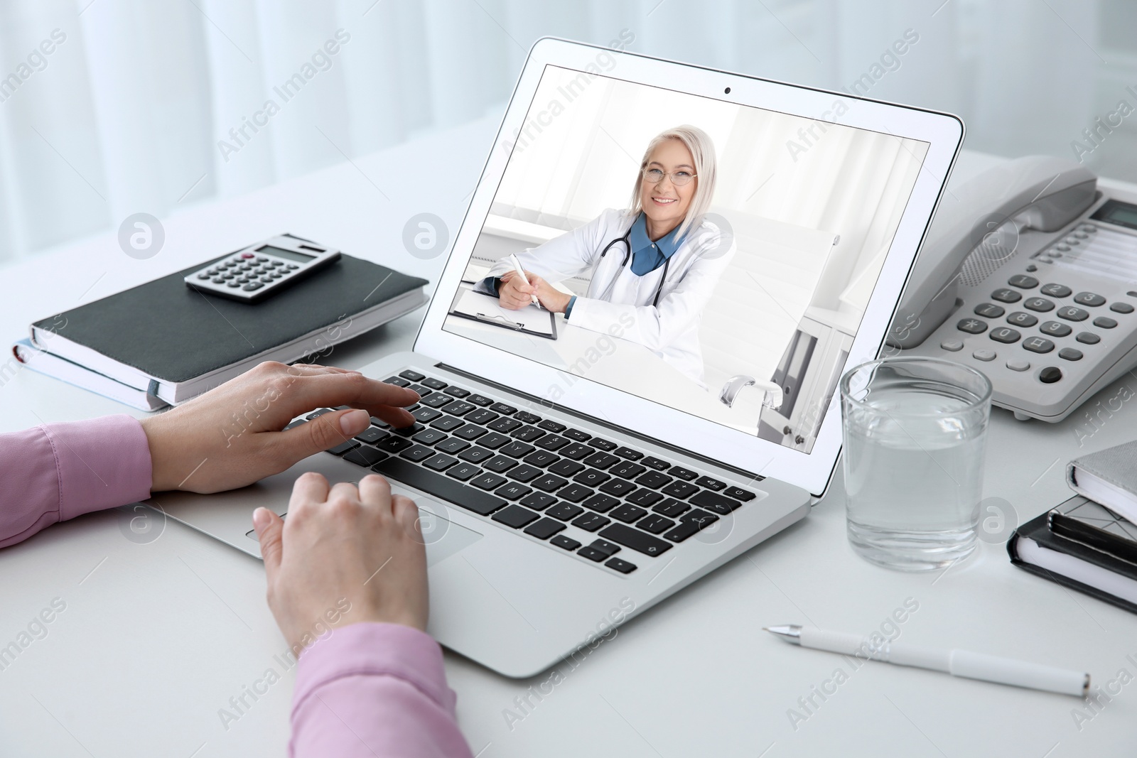 Image of Woman using laptop for online consultation with mature female doctor, closeup 