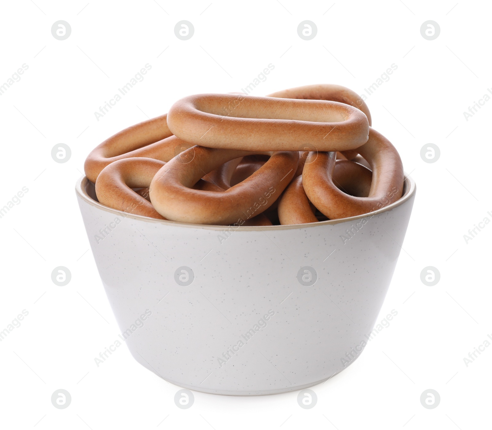 Photo of Bowl with tasty dry bagels (sushki) isolated on white
