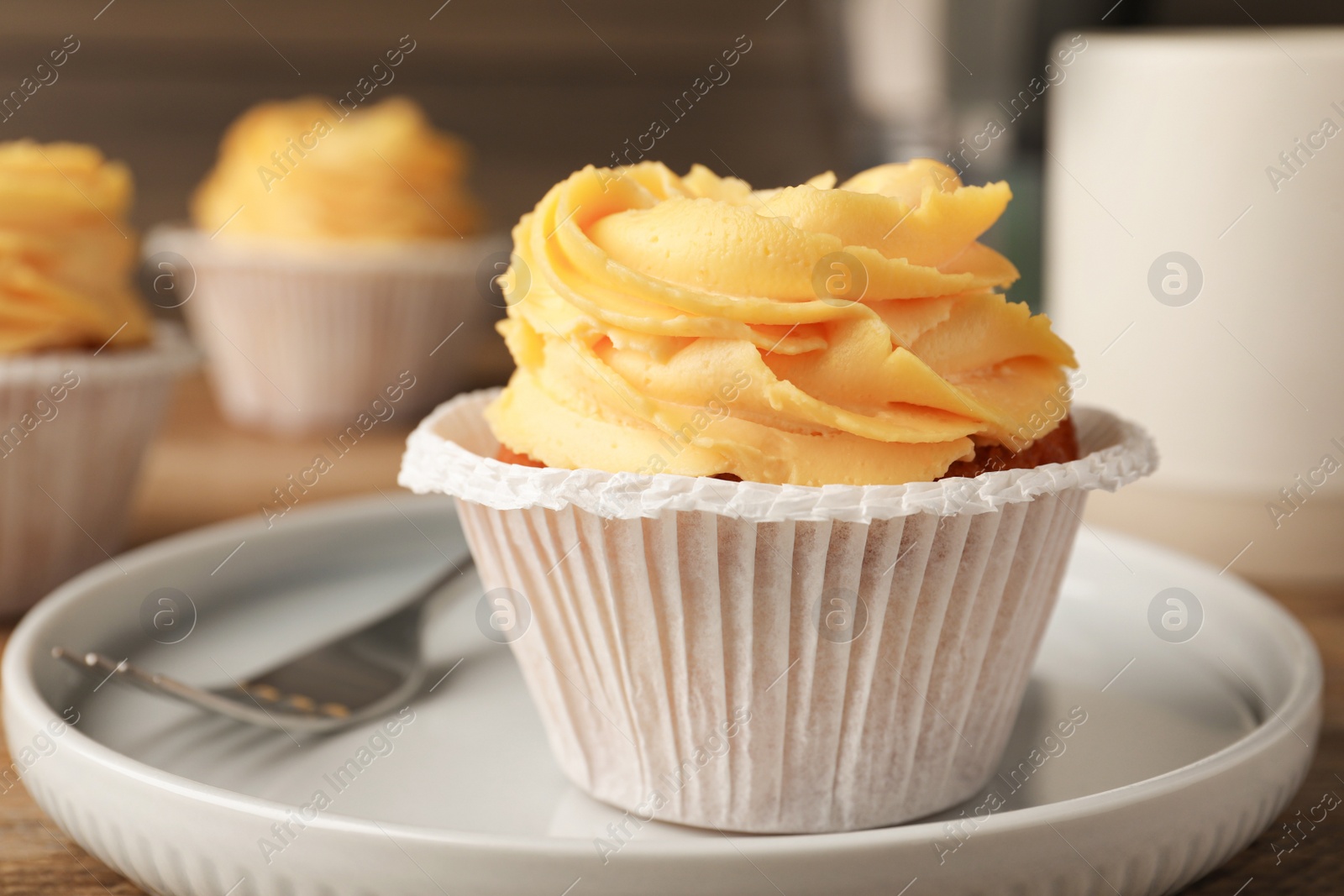 Photo of Tasty cupcake with cream served on plate, closeup