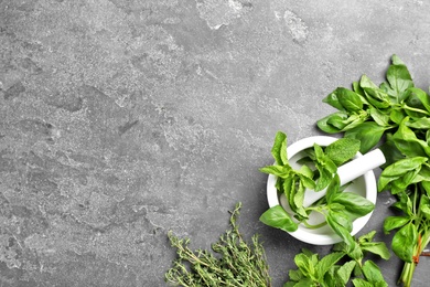 Flat lay composition with fresh green herbs on grey background