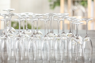 Empty glasses on wooden table against blurred background