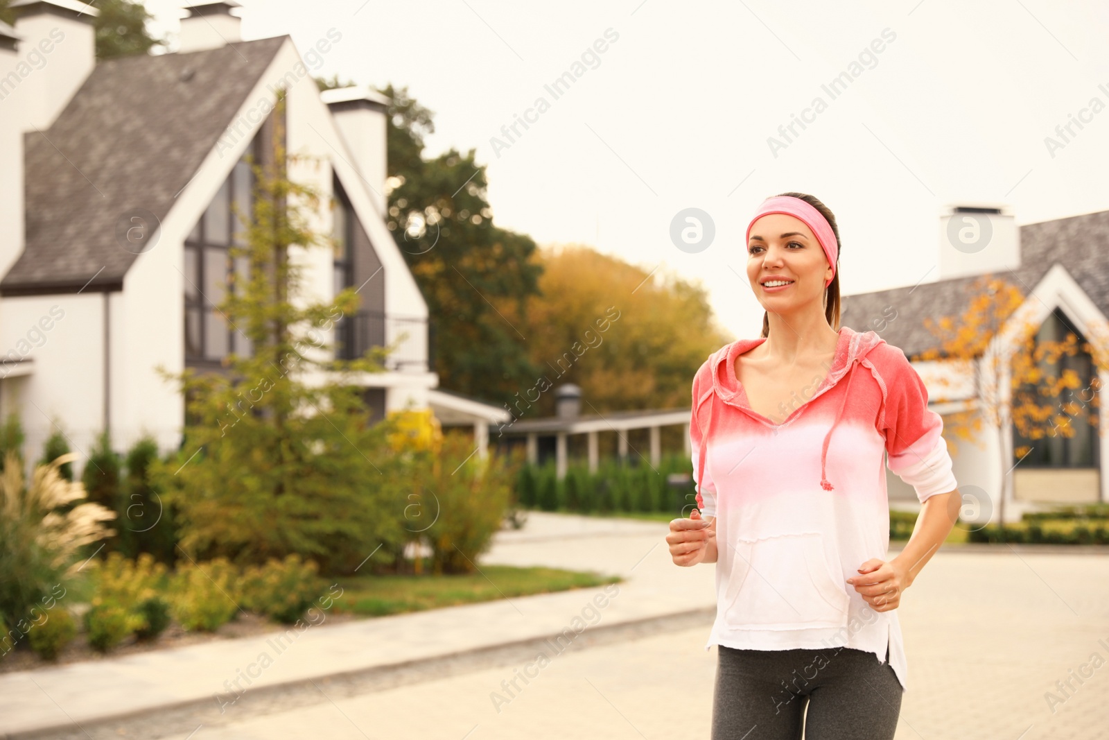 Photo of Beautiful sporty woman running on street. Healthy lifestyle