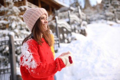 Young woman outdoors on snowy day. Winter vacation