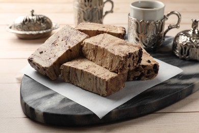 Photo of Tasty chocolate halva on wooden table, closeup