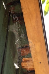 Photo of Cobweb on wooden building outdoors, low angle view