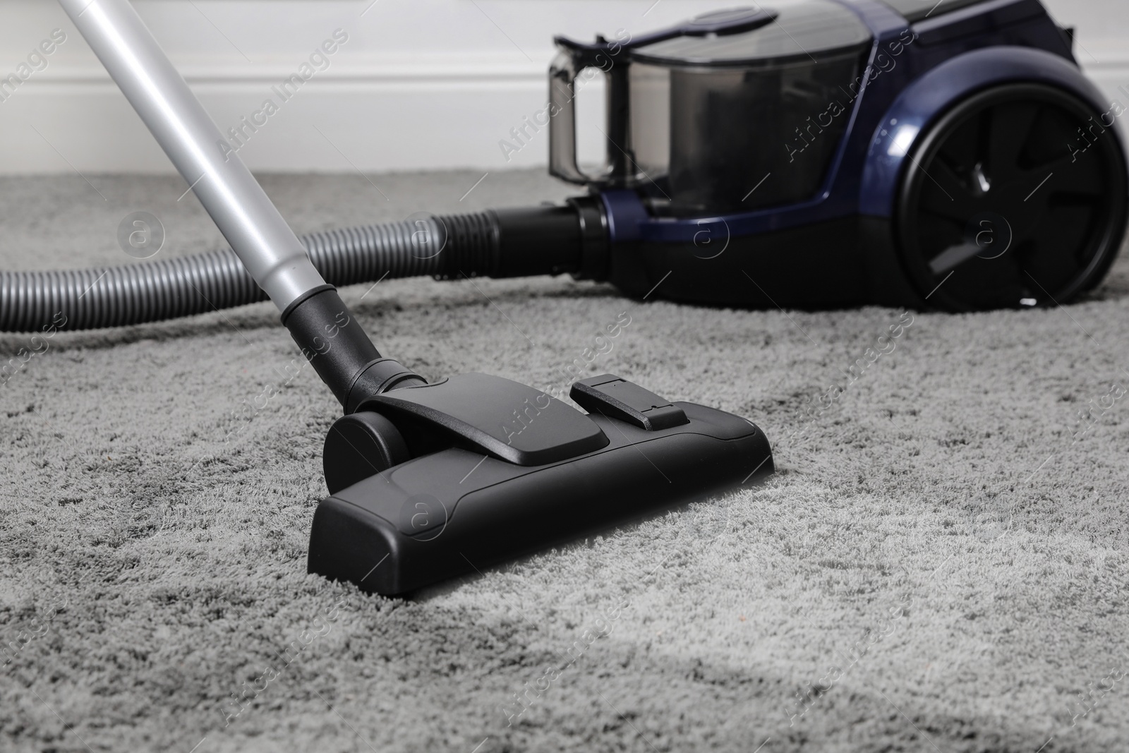 Image of Vacuuming carpet. Clean area after using device in room, closeup