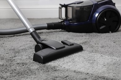 Vacuuming carpet. Clean area after using device in room, closeup