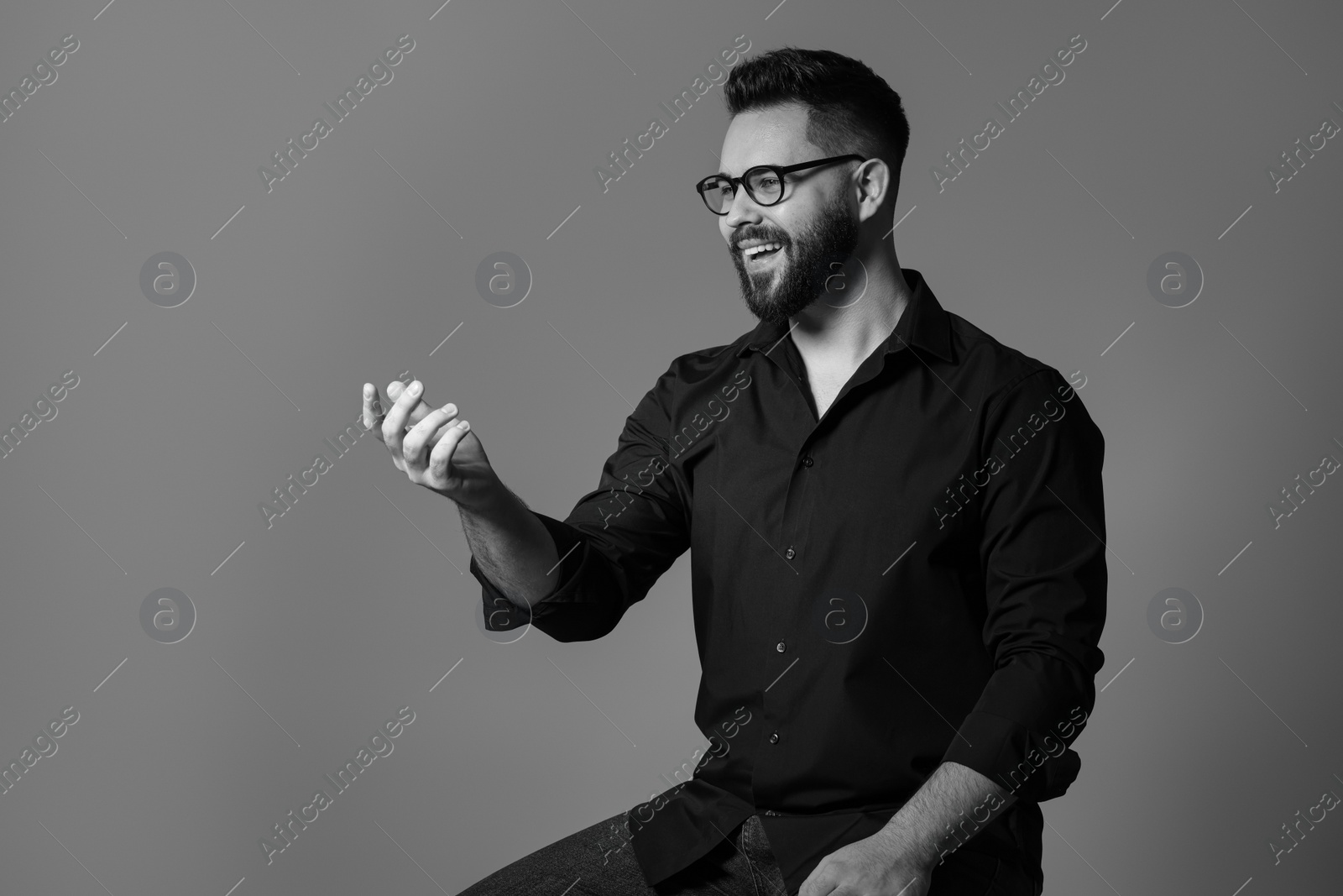 Photo of Portrait of handsome bearded man on grey background, space for text. Black and white effect