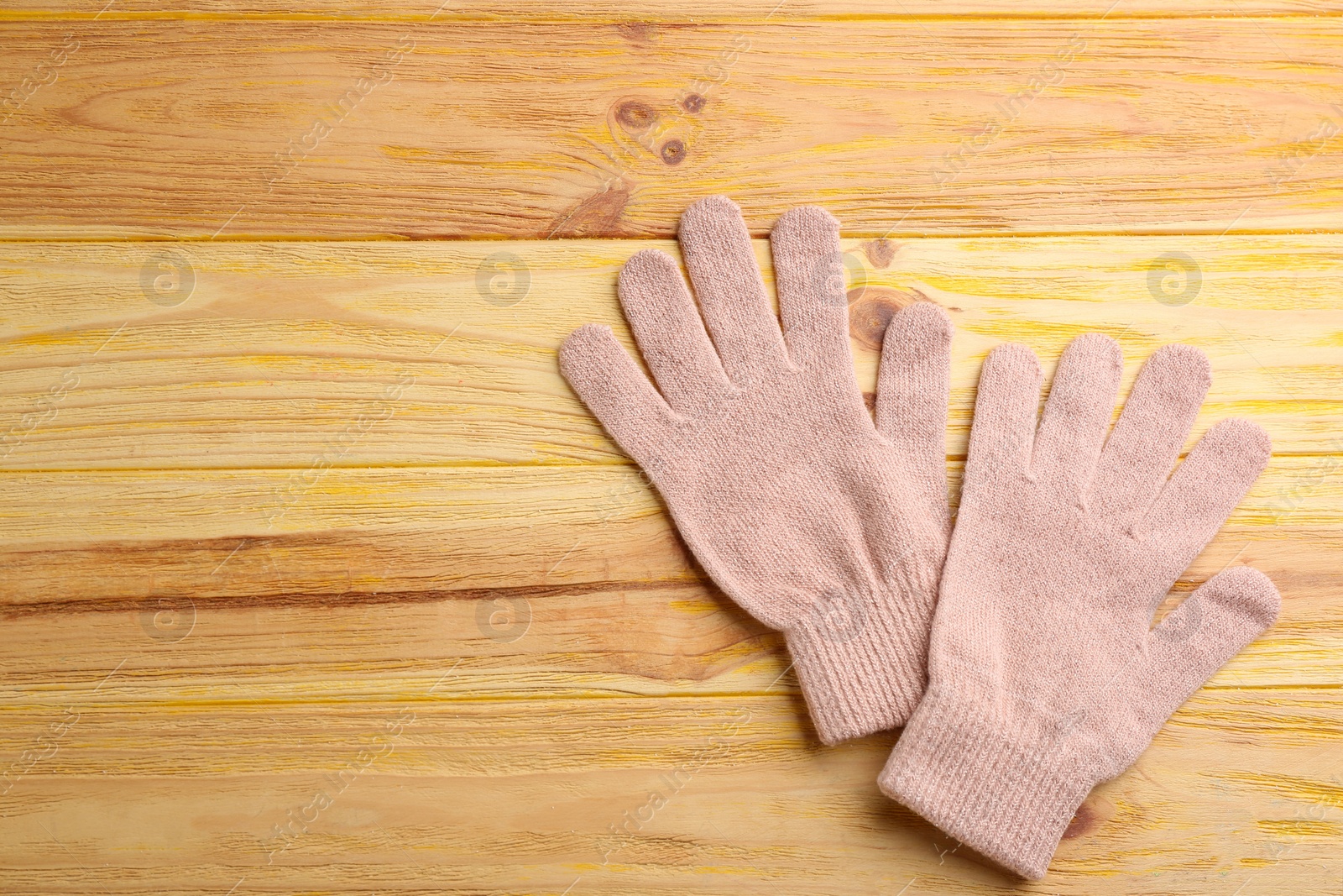 Photo of Stylish pink gloves on wooden background, flat lay. Space for text