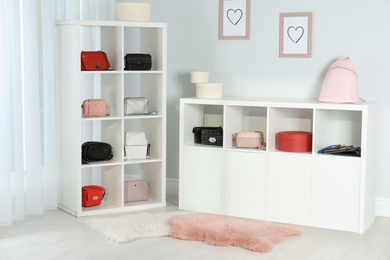 Photo of Wardrobe shelves with different stylish bags indoors. Idea for interior design
