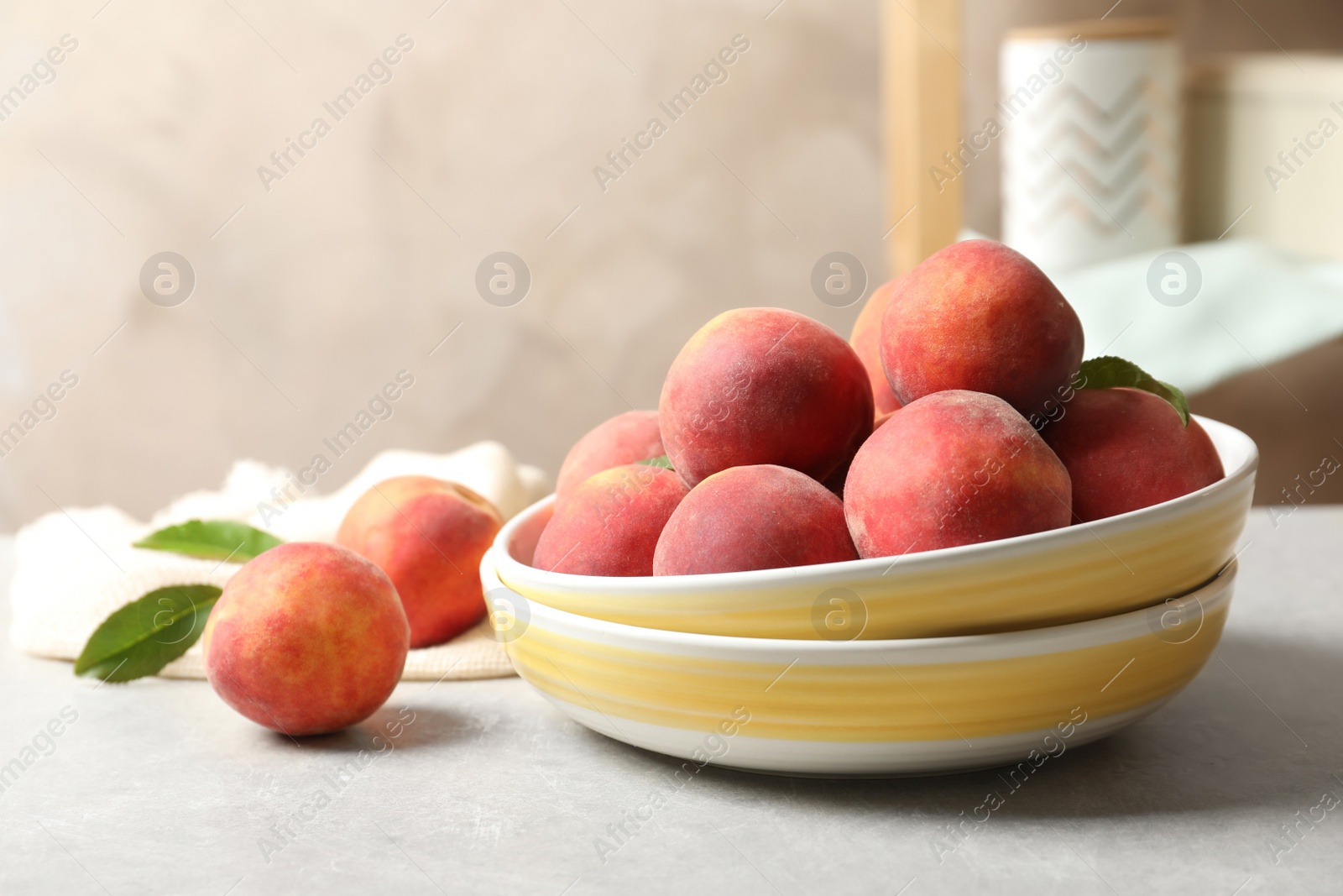 Photo of Plates with fresh sweet peaches on table