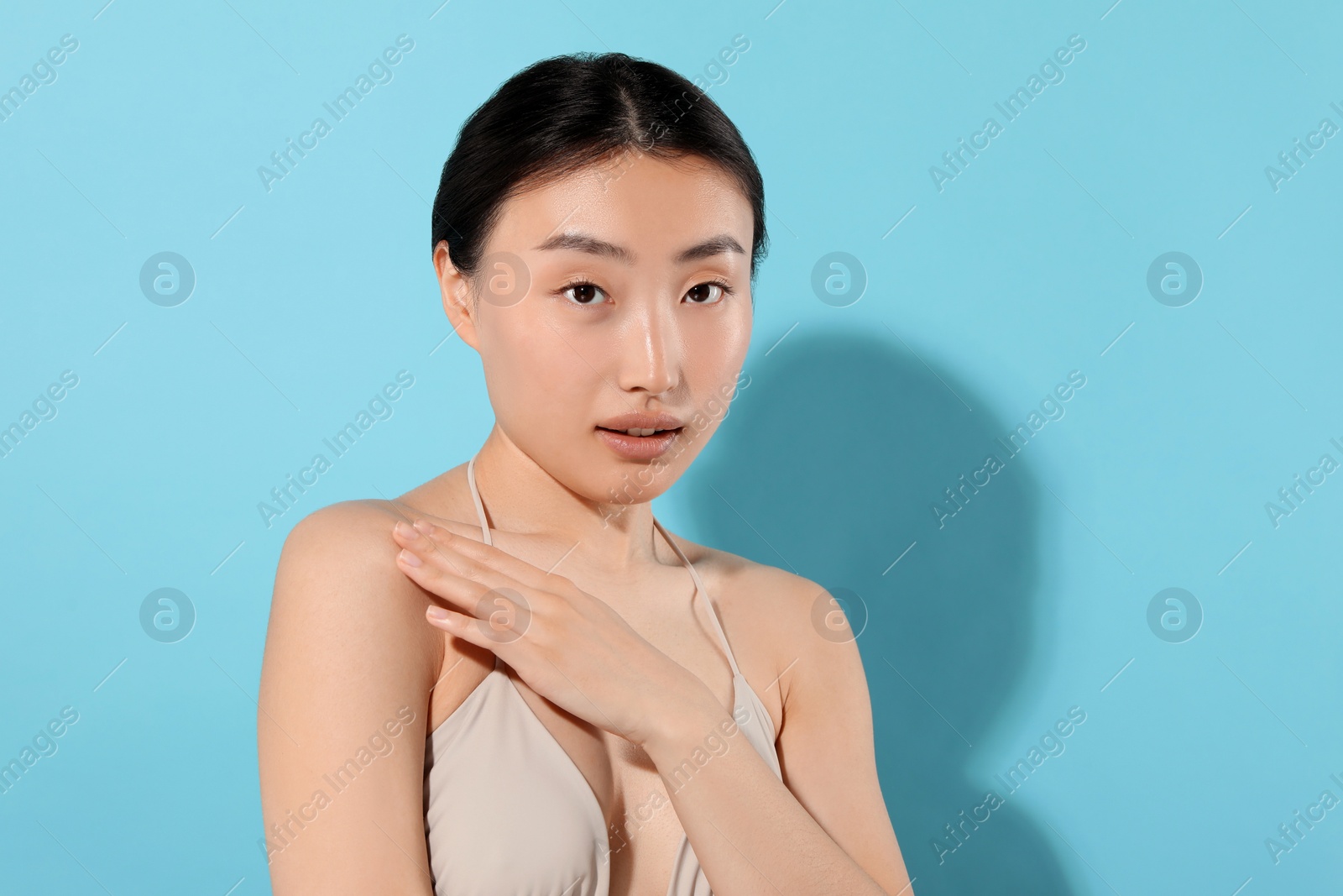 Photo of Beautiful young woman on light blue background