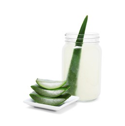 Photo of Fresh aloe juice in jar and cut leaves isolated on white