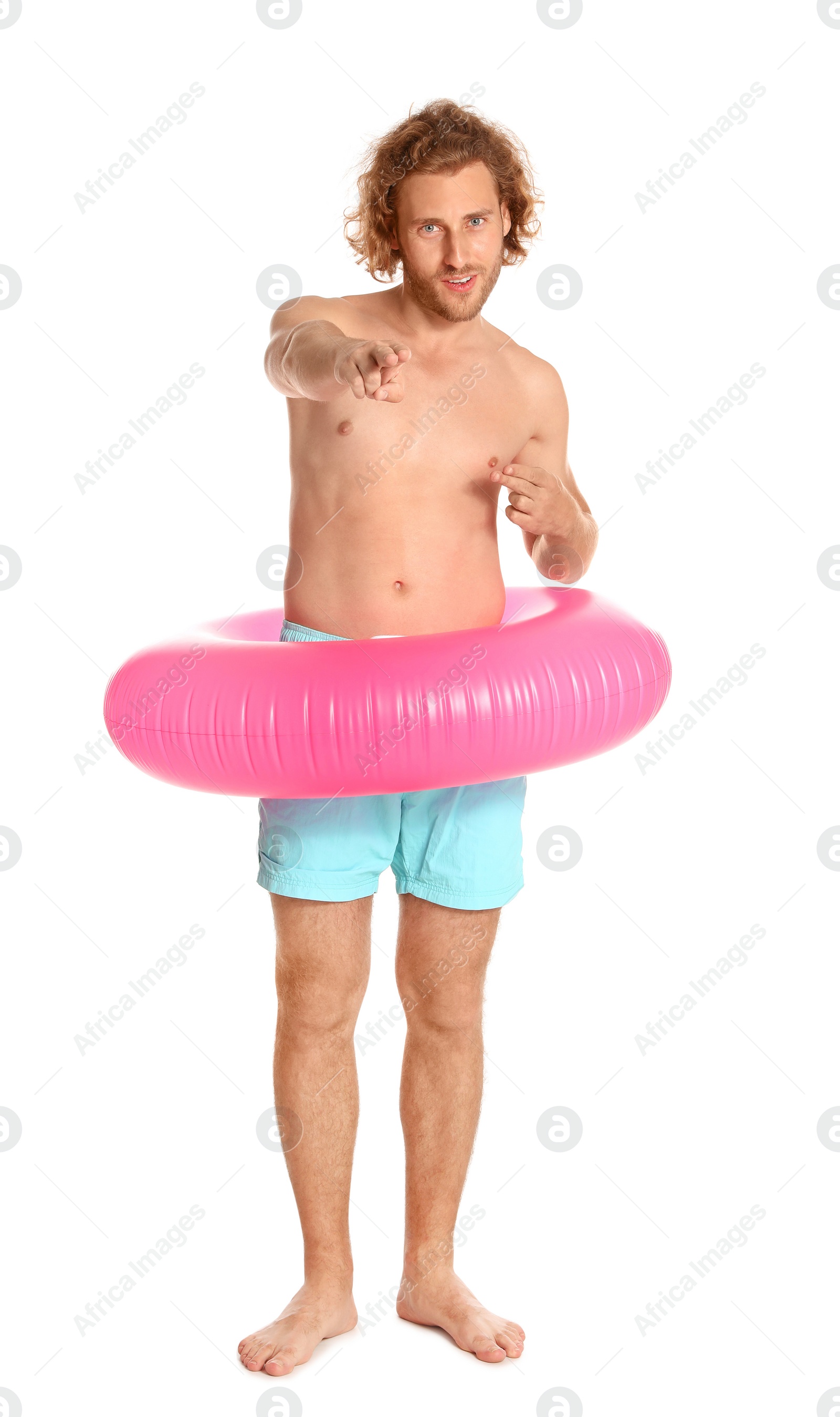 Photo of Attractive young man in swimwear with pink inflatable ring on white background
