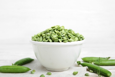 Photo of Ceramic bowl with dried peas on table