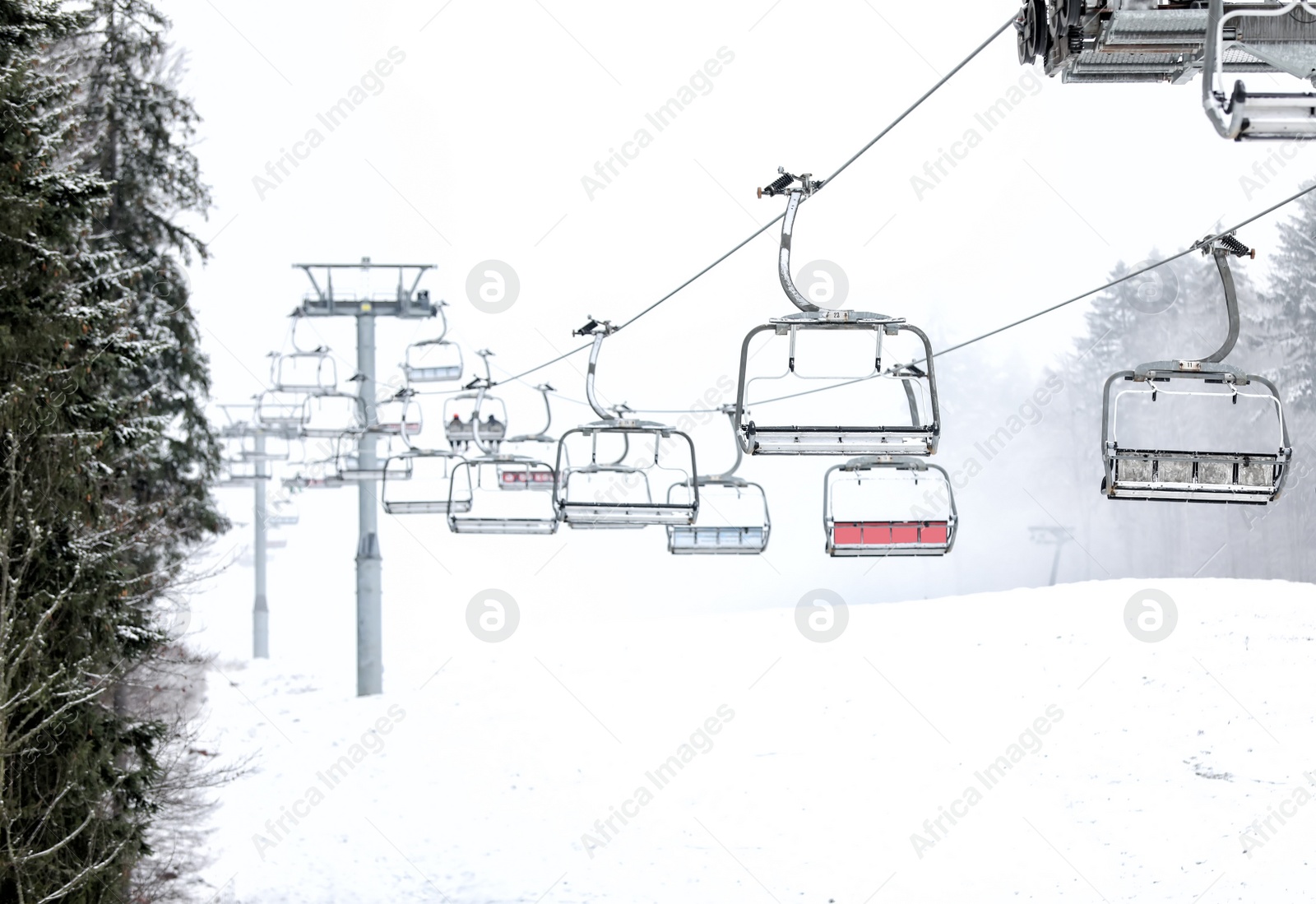 Photo of Ski lift at mountain resort. Winter vacation