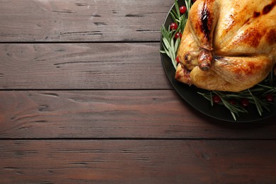 Delicious cooked turkey served on wooden table, top view with space for text. Thanksgiving Day celebration