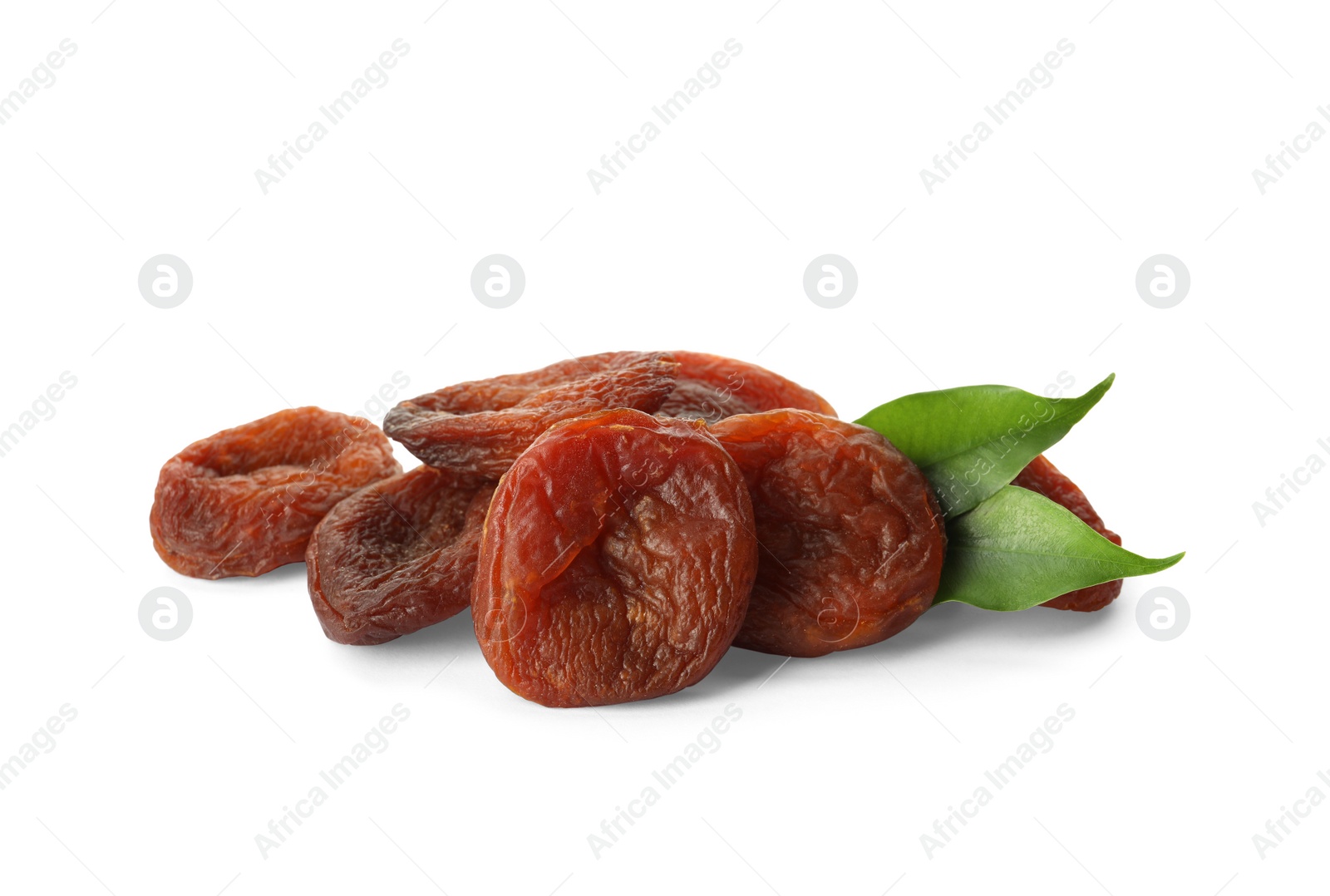 Photo of Tasty dried apricots and leaves on white background