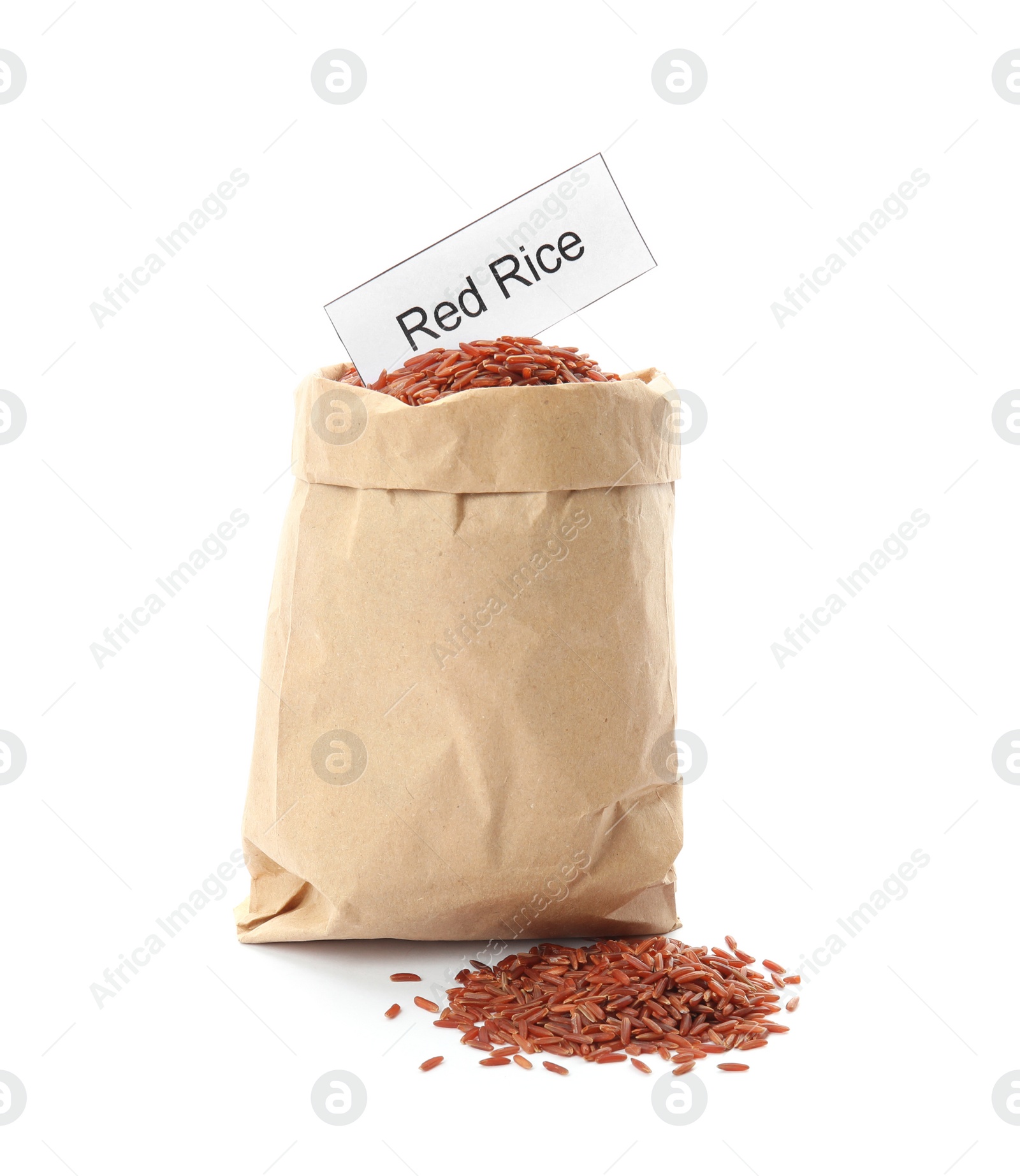 Photo of Paper bag with uncooked red rice and card on white background