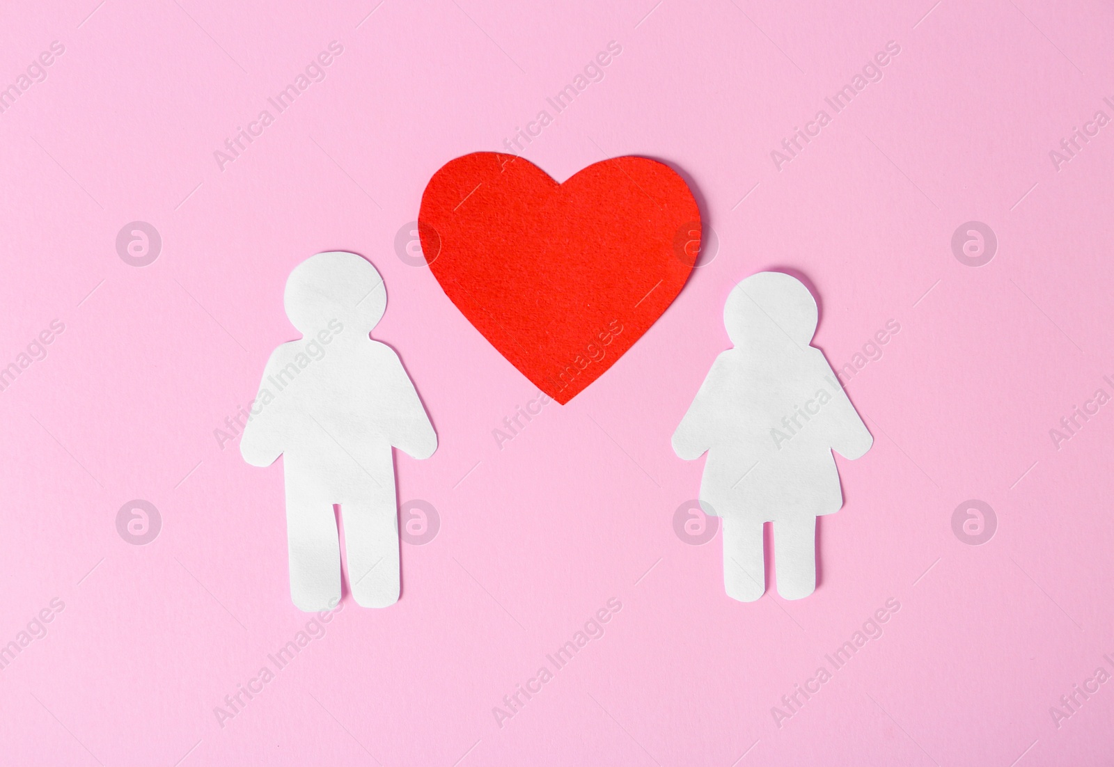 Photo of Paper couple with red heart on color background. Romantic feelings