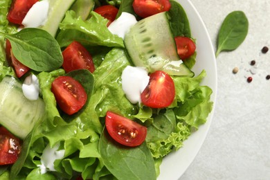 Delicious vegetable salad on light grey table, flat lay. Space for text