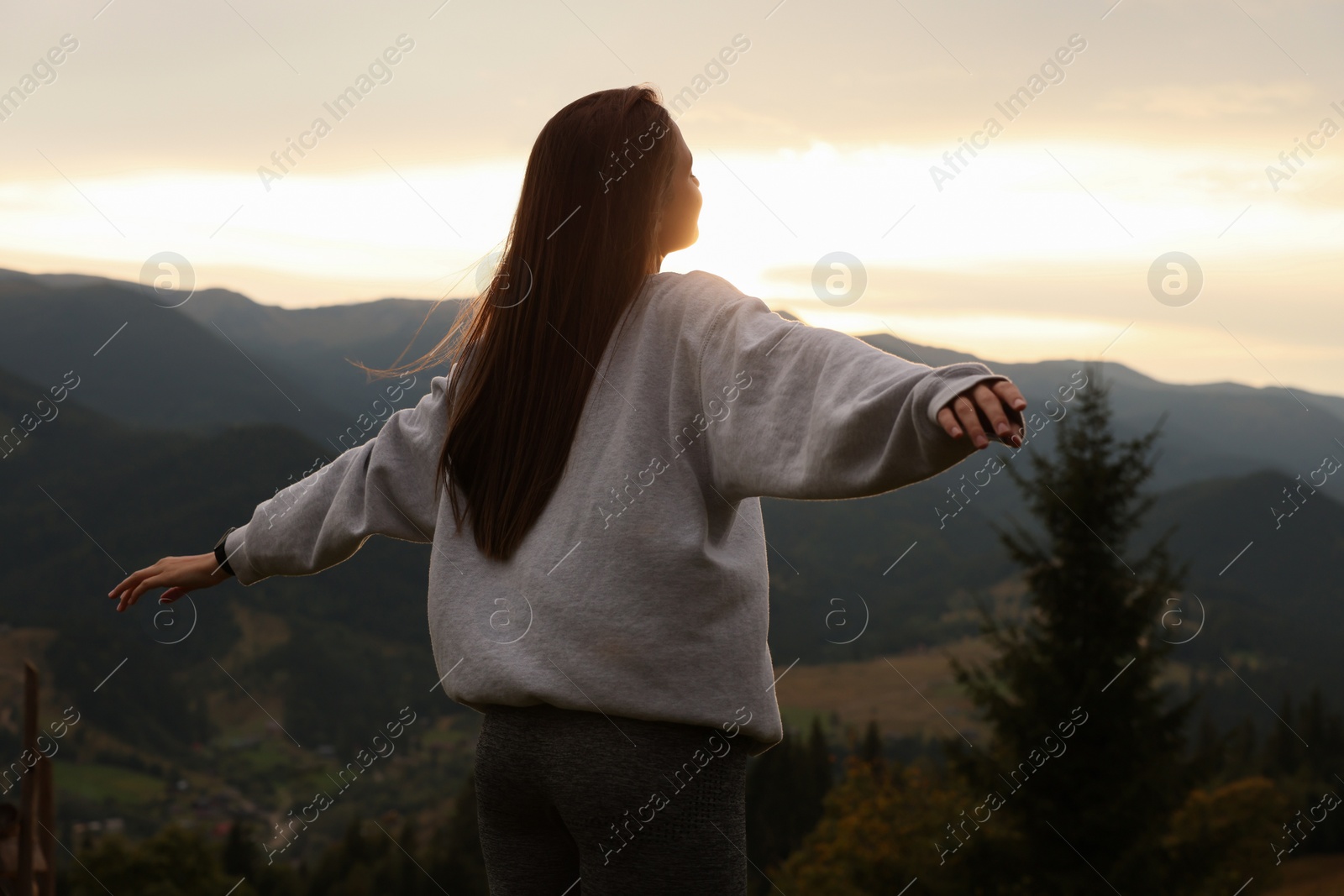 Photo of Beautiful young woman enjoying her time in mountains