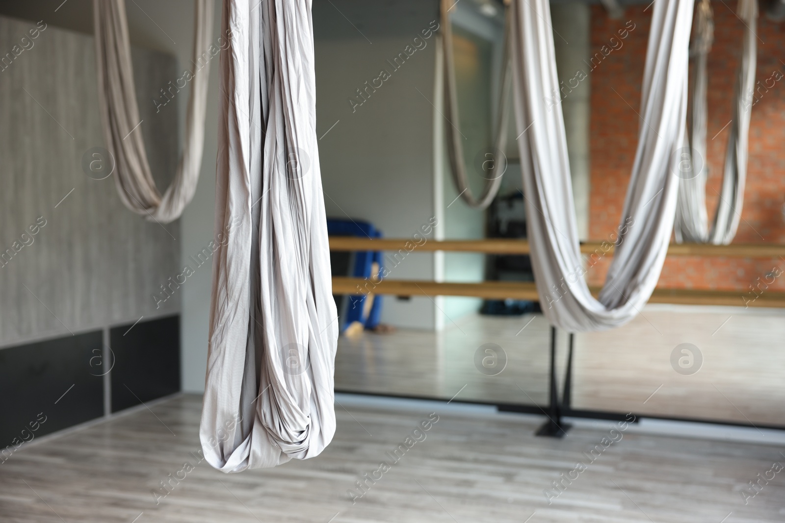 Photo of Many hammocks for fly yoga in studio, space for text