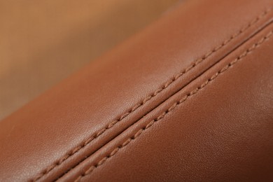 Photo of Texture of brown leather as background, closeup