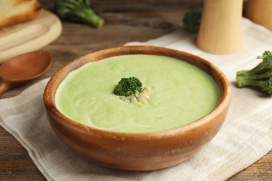 Delicious broccoli cream soup served on wooden table