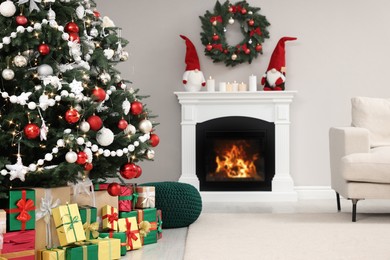 Beautiful Christmas tree and many gift boxes in stylish living room interior