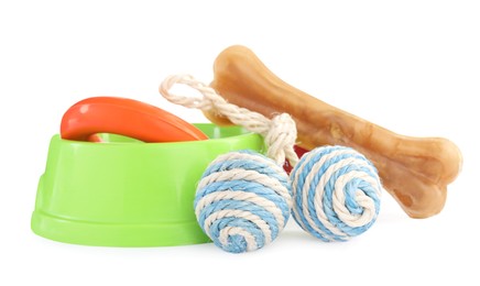 Photo of Pet toys, bowl and dog treat isolated on white