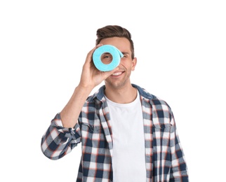 Young man looking through toilet paper roll on white background