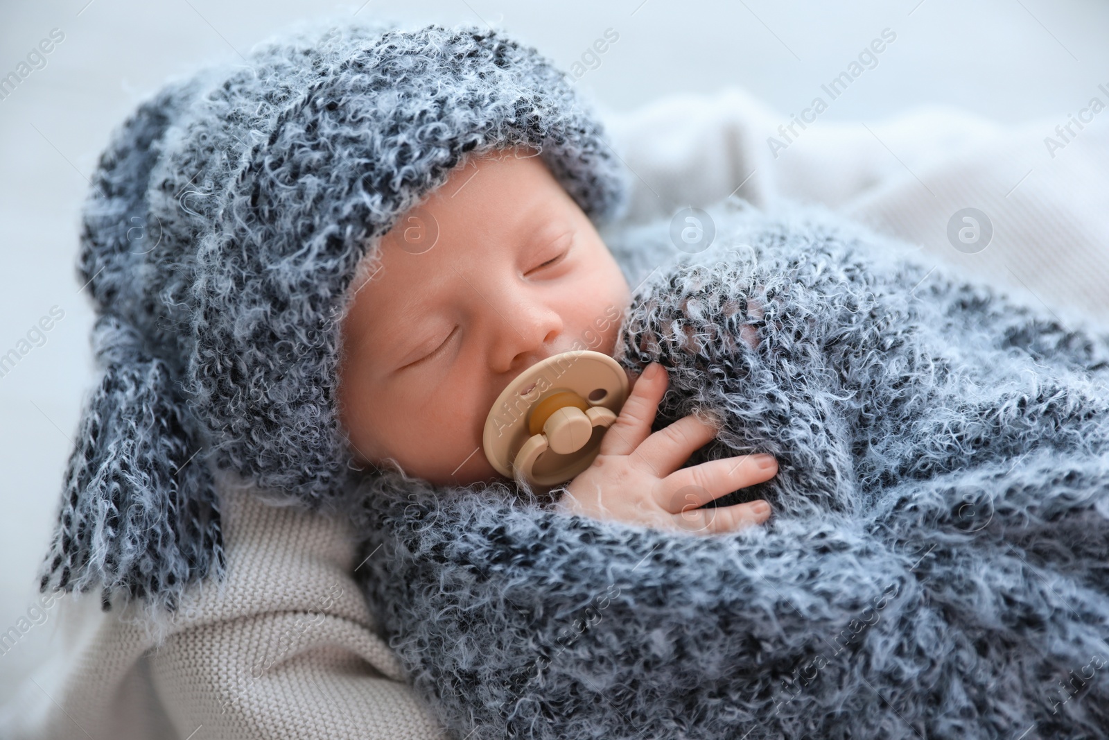 Photo of Cute newborn baby sleeping on plaid at home