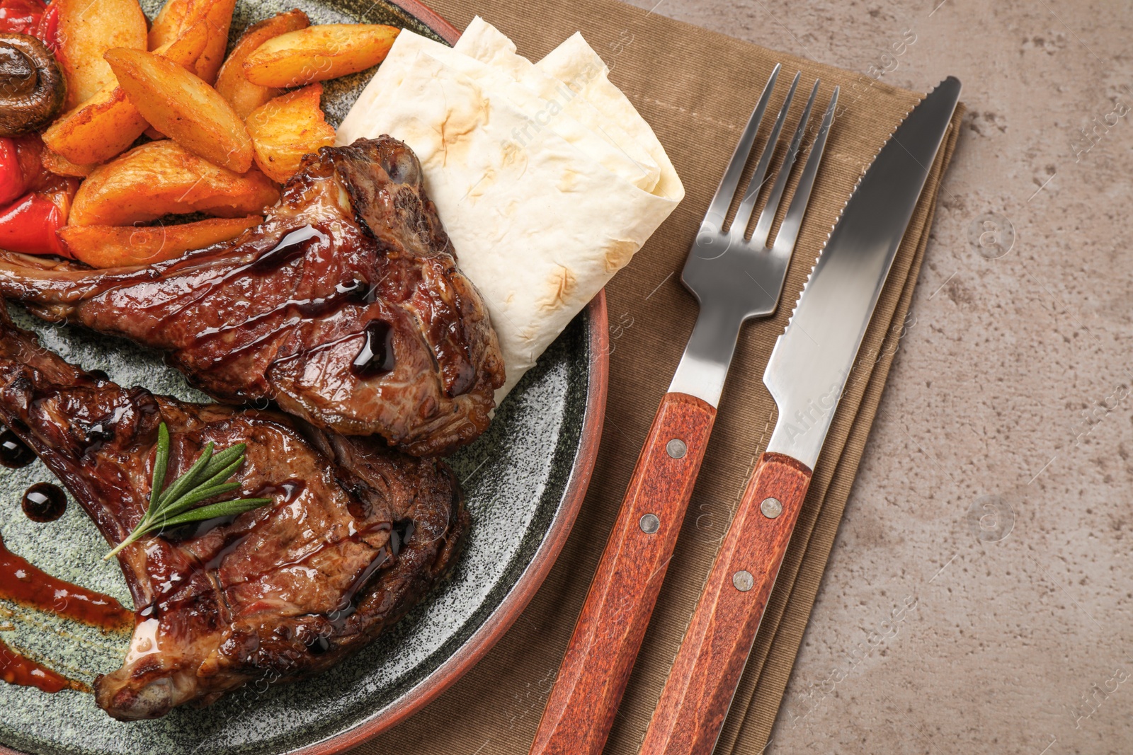 Photo of Delicious grilled ribs served on light grey table, flat lay