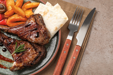 Delicious grilled ribs served on light grey table, flat lay