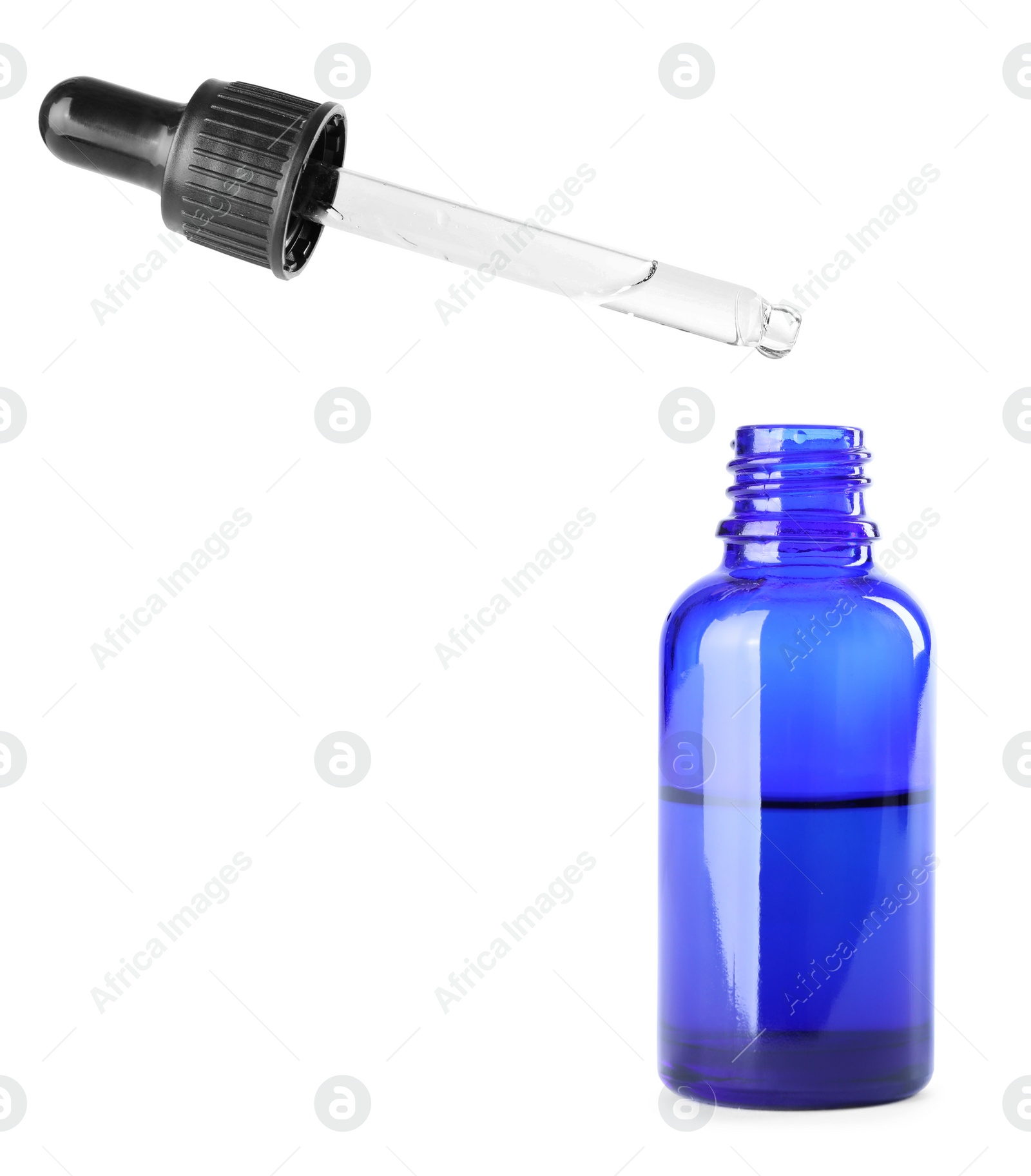 Photo of Dropping herbal essential oil into bottle isolated on white