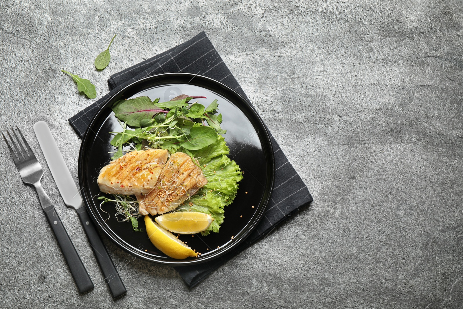 Photo of Tasty grilled fish on grey table, flat lay. Space for text