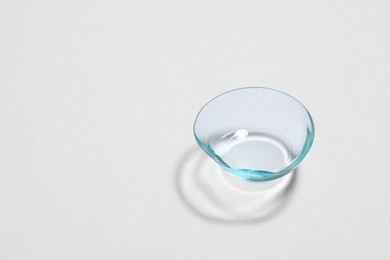 Photo of One contact lens on white background, space for text