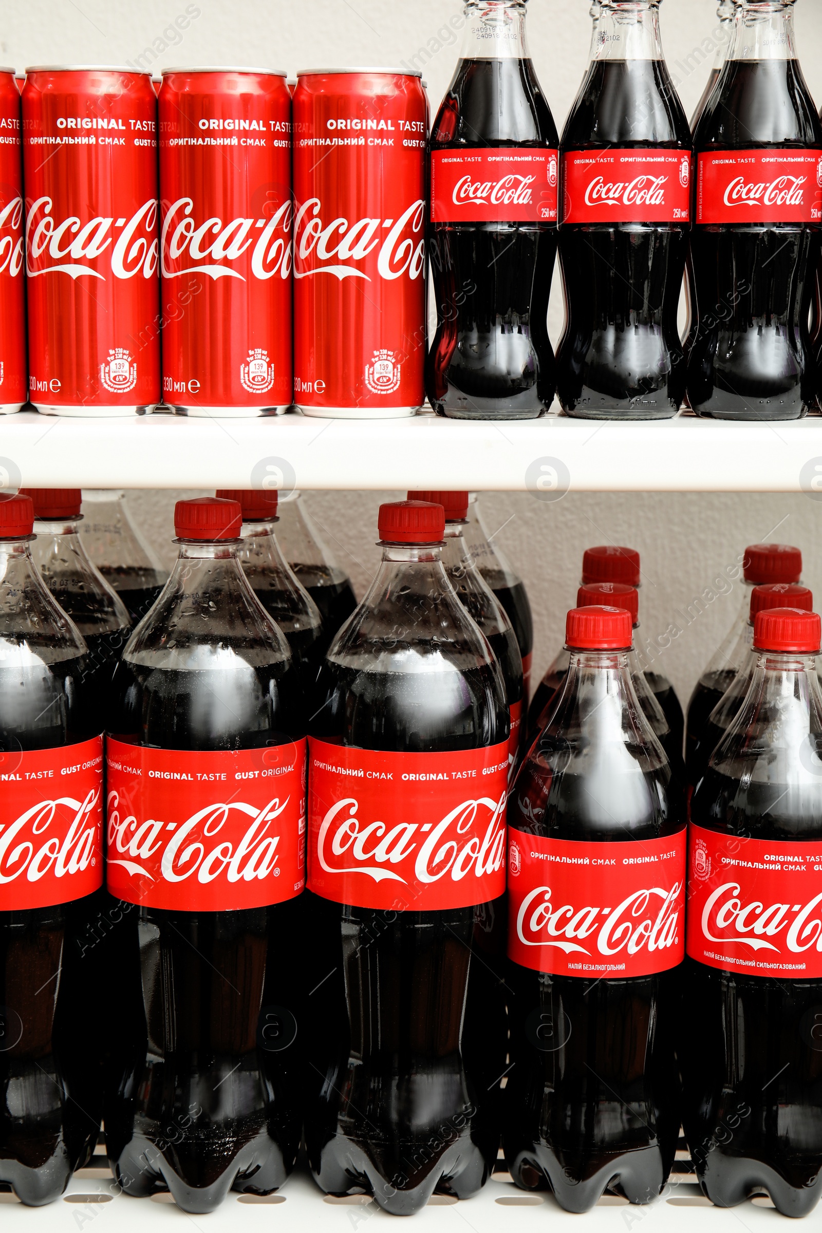 Photo of MYKOLAIV, UKRAINE - NOVEMBER 14, 2018: Coca-Cola cans and bottles on display in store