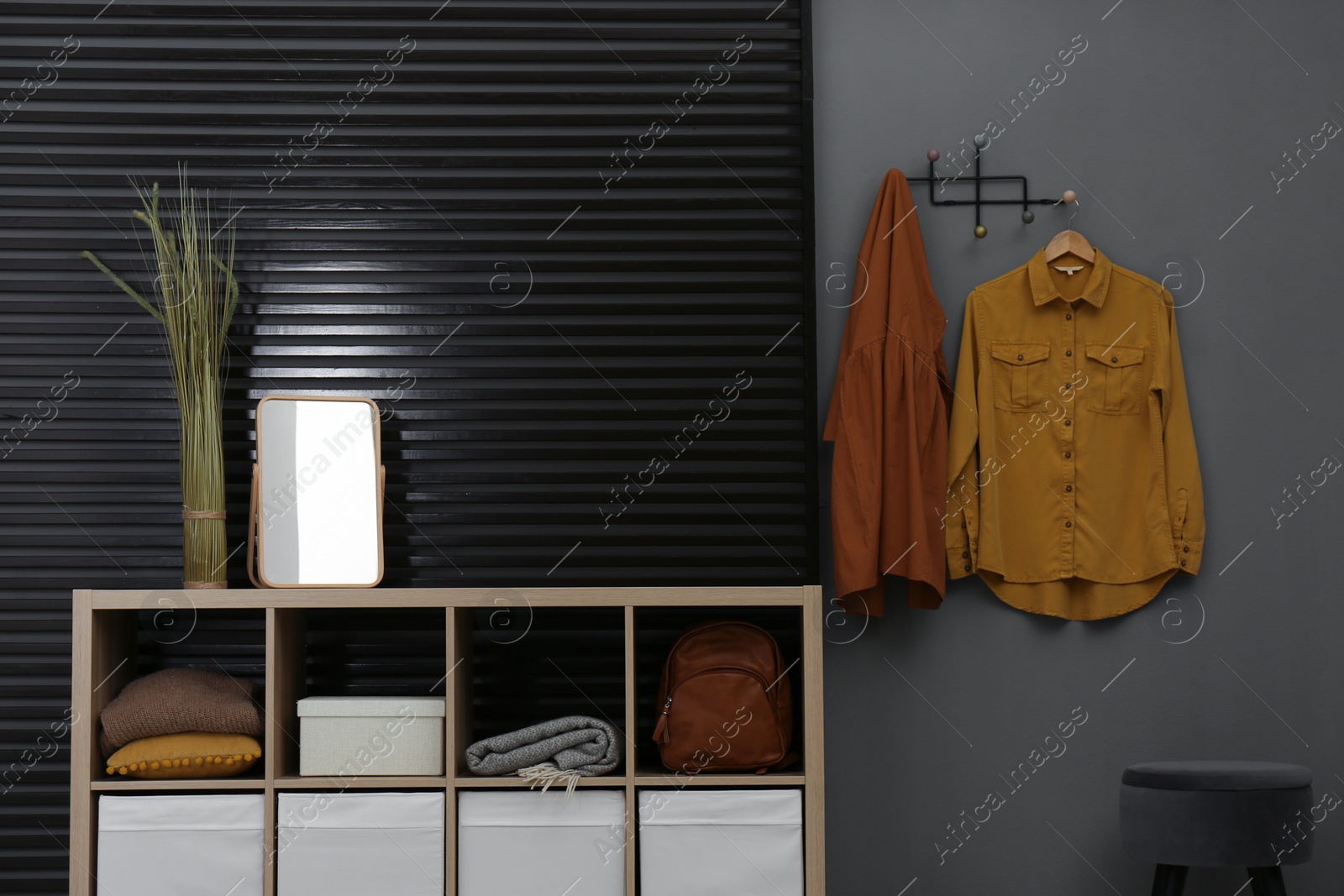 Photo of Hallway interior with stylish furniture, clothes and accessories