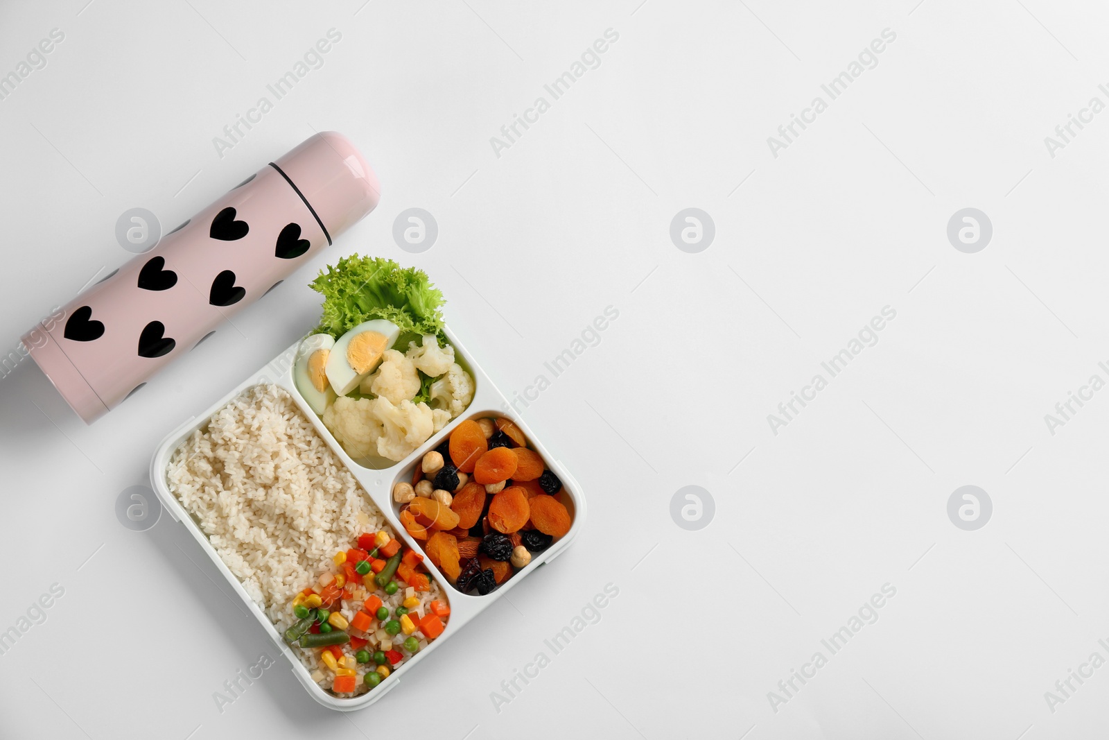 Photo of Thermos and lunch box with food on white background, top view