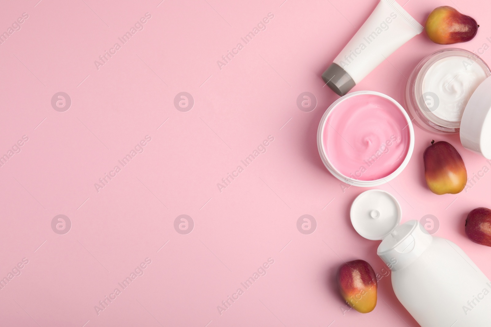 Image of Fresh ripe palm oil fruits and cosmetic products on pink background, flat lay. Space for text