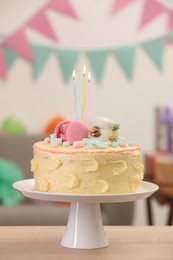 Photo of Delicious cake decorated with macarons and marshmallows on wooden table against blurred background