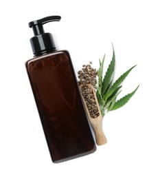 Photo of Bottle of hemp cosmetics with green leaves and seeds isolated on white, top view