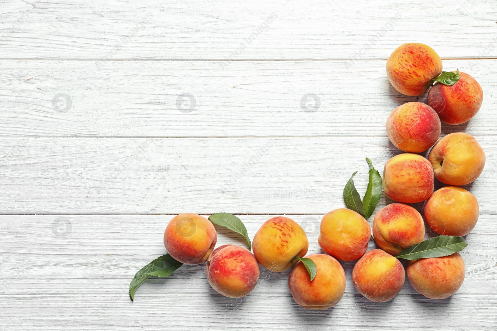 Photo of Flat lay composition with ripe peaches on wooden background