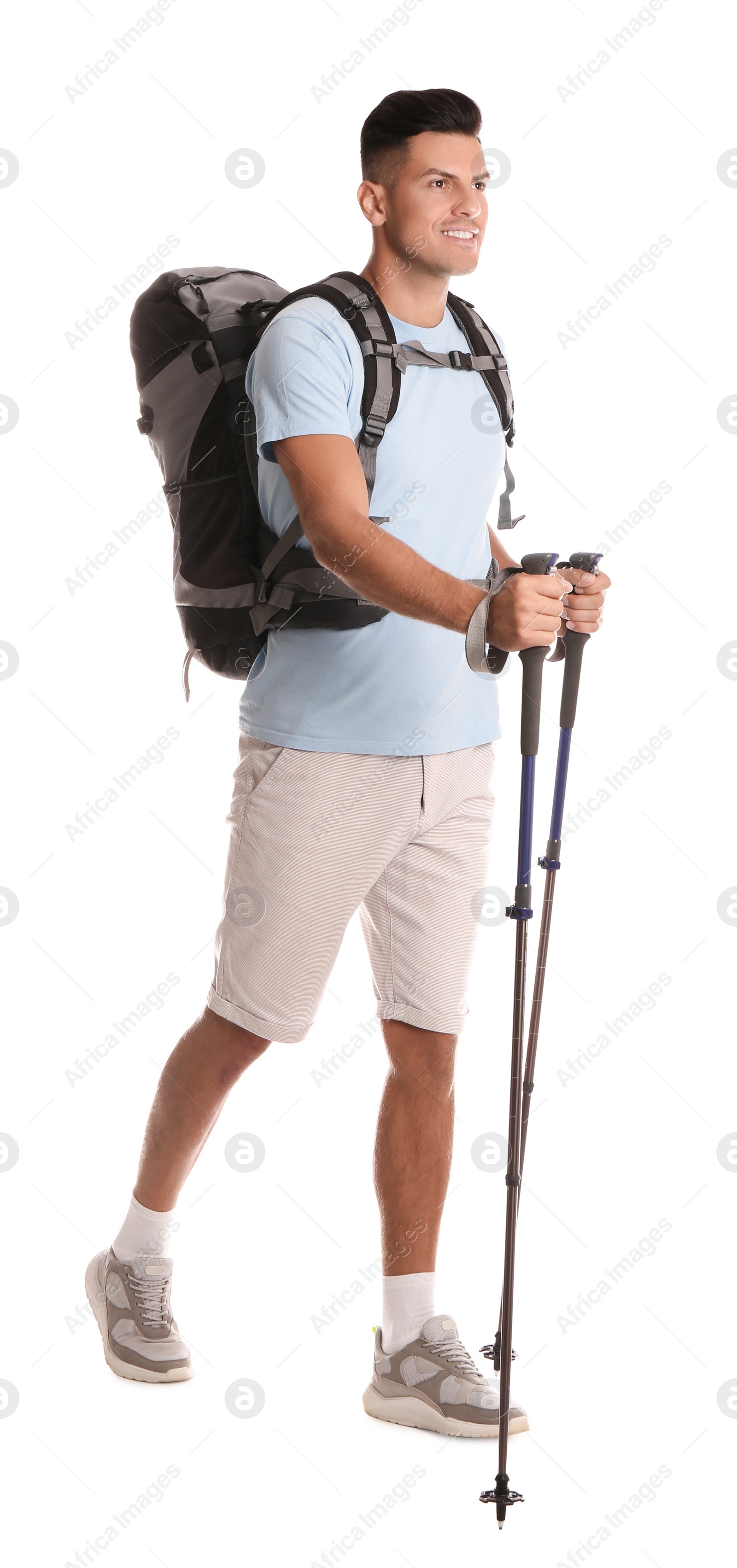 Photo of Male hiker with backpack and trekking poles on white background