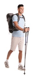 Male hiker with backpack and trekking poles on white background